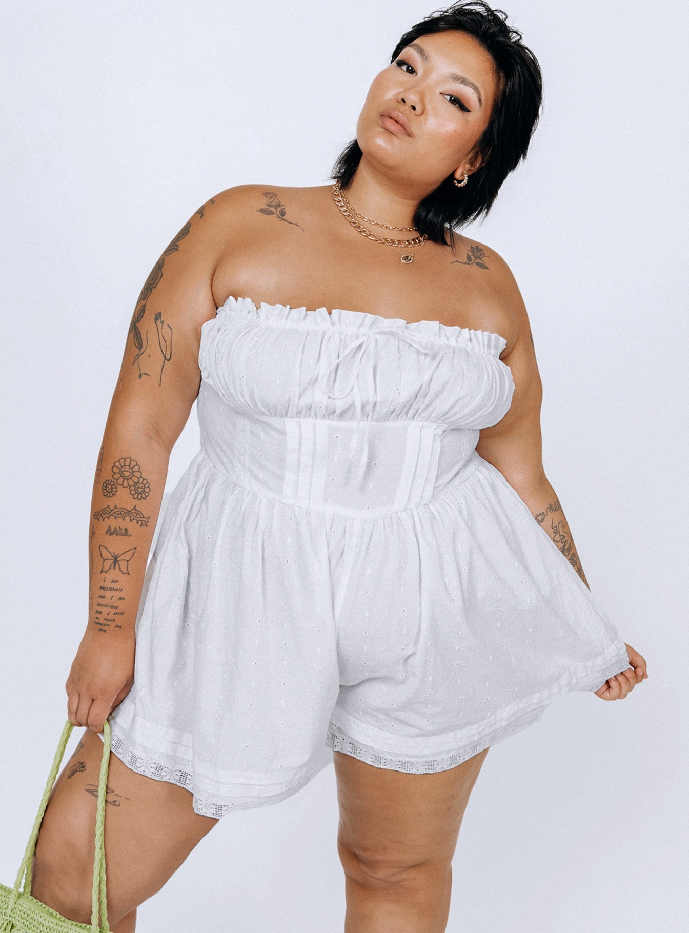 Strapless romper Lace details Ruffle neckline  Adjustable tie at neckline  Shirred back  Twin hip pockets  Non-stretch