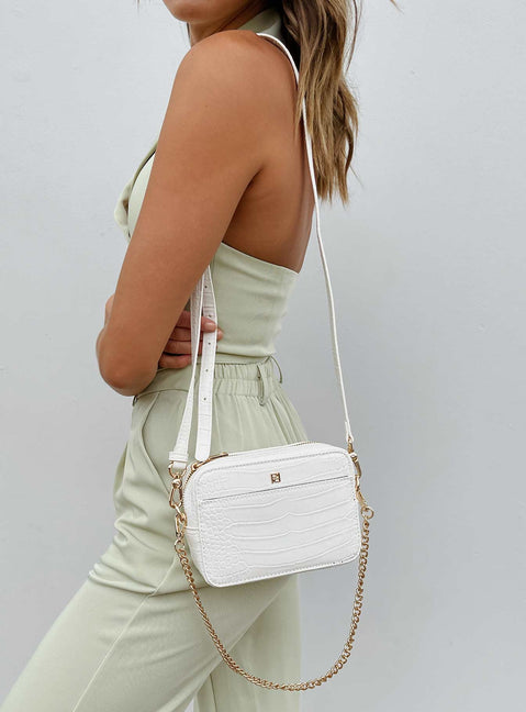 Crossbody bag 40% post-consumer recycled polyester 18% post-consumer recycled polyurethane 18% polyurethane 14% calcium carbonate 10% wood fiber Faux croc leather  Removable chain shoulder strap  Removable / adjustable crossbody strap  Zip fastening  Internal pockets  Flat base 