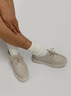 Shoes Faux leather material  High shine  Lace up  Rounded toe  Pull tab at heel  Platform base  Treaded sole 