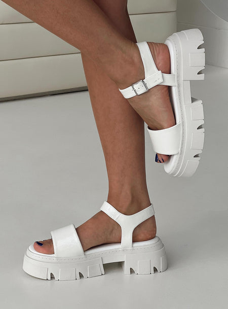 Sandals Strappy upper, faux leather, silver-toned hardware, buckle fastening, platform base,        treaded sole, rounded toe