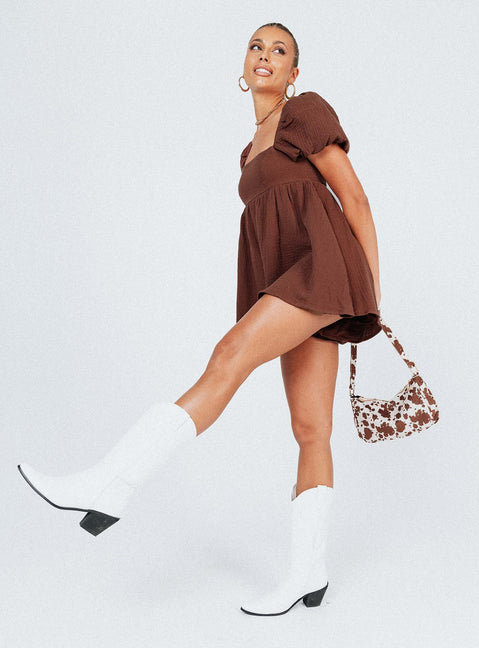 Romper Muslin material Square neckline  Elasticated puff sleeves Shirred back panel Invisible zip fastening at back  Relaxed leg 