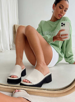 Sandals Faux leather material Single stretch knit upper Padded footbed Square toe Slip-on style