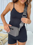 Crossbody bag Faux leather trims Adjustable & removable strap Two separate compartments Zip fastening Silver-toned hardware Branded plaque at front Flat base