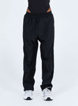 Black pants Windbreaker material Elasticated waistband Twin hip pockets Elasticated cuffs
