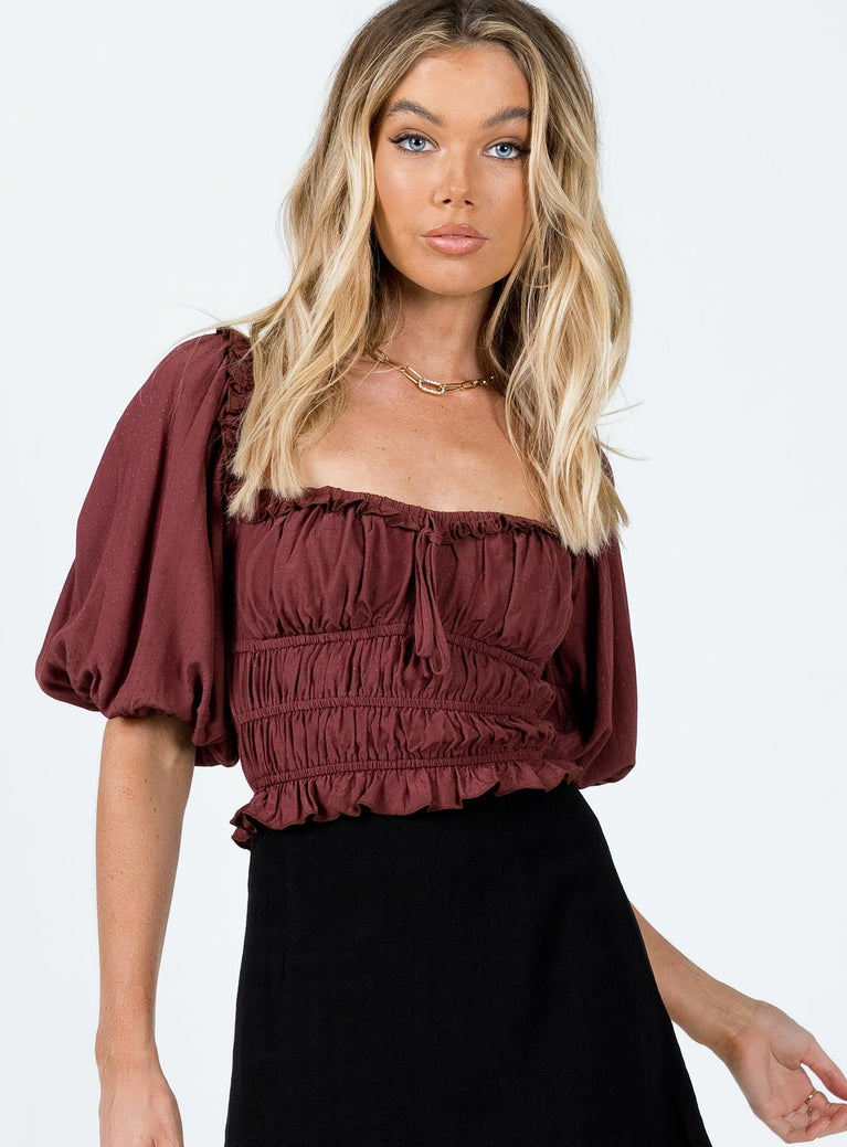 Crop top Elasticated neckline & waist Can be worn on or off the shoulder Puff sleeves Tie detail at front Frill hem 