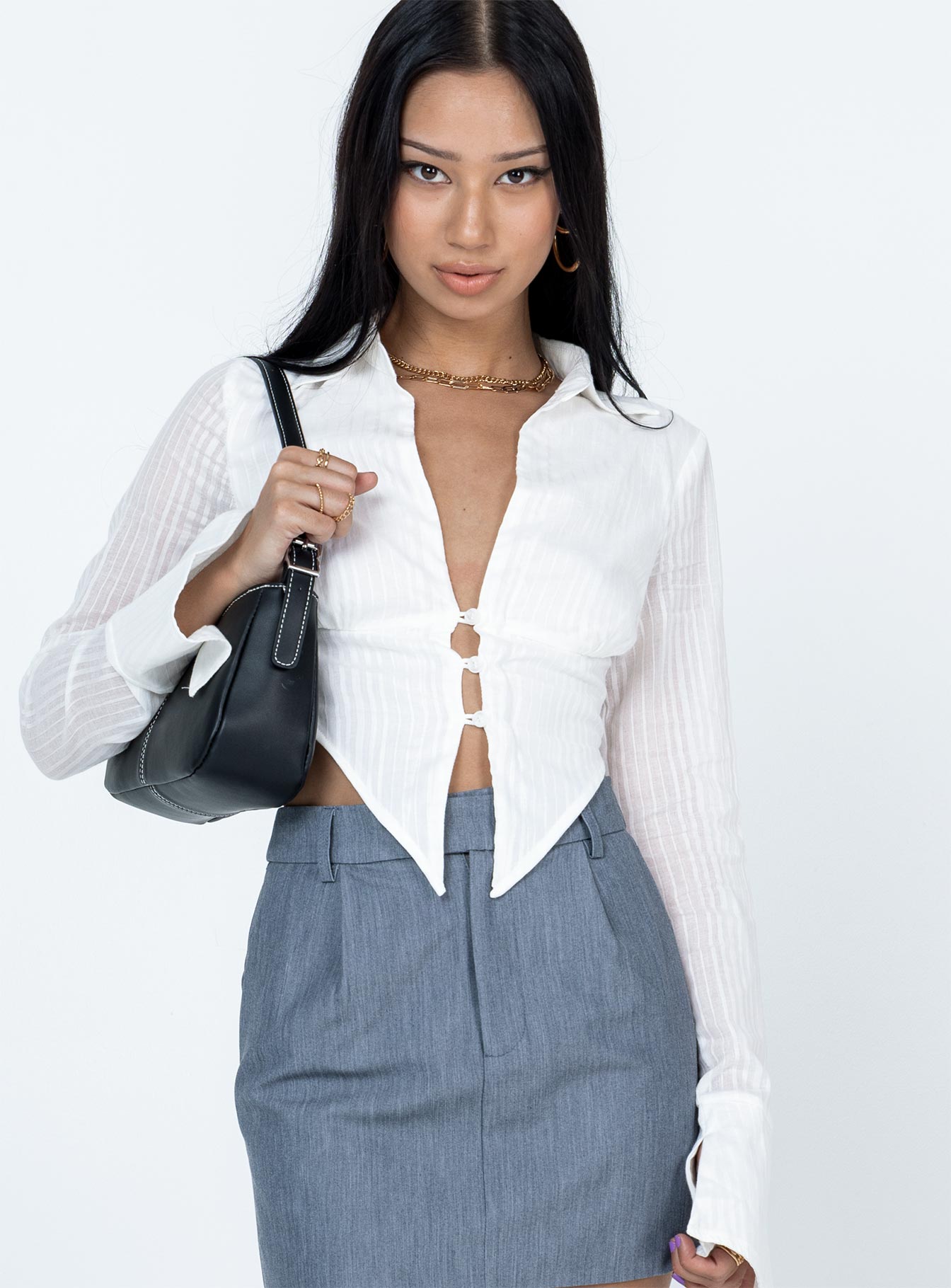 Long sleeve top Sheer material  Classic collar  V neckline  Single bust fastening at bust  Pointed hem  Flared cuffs