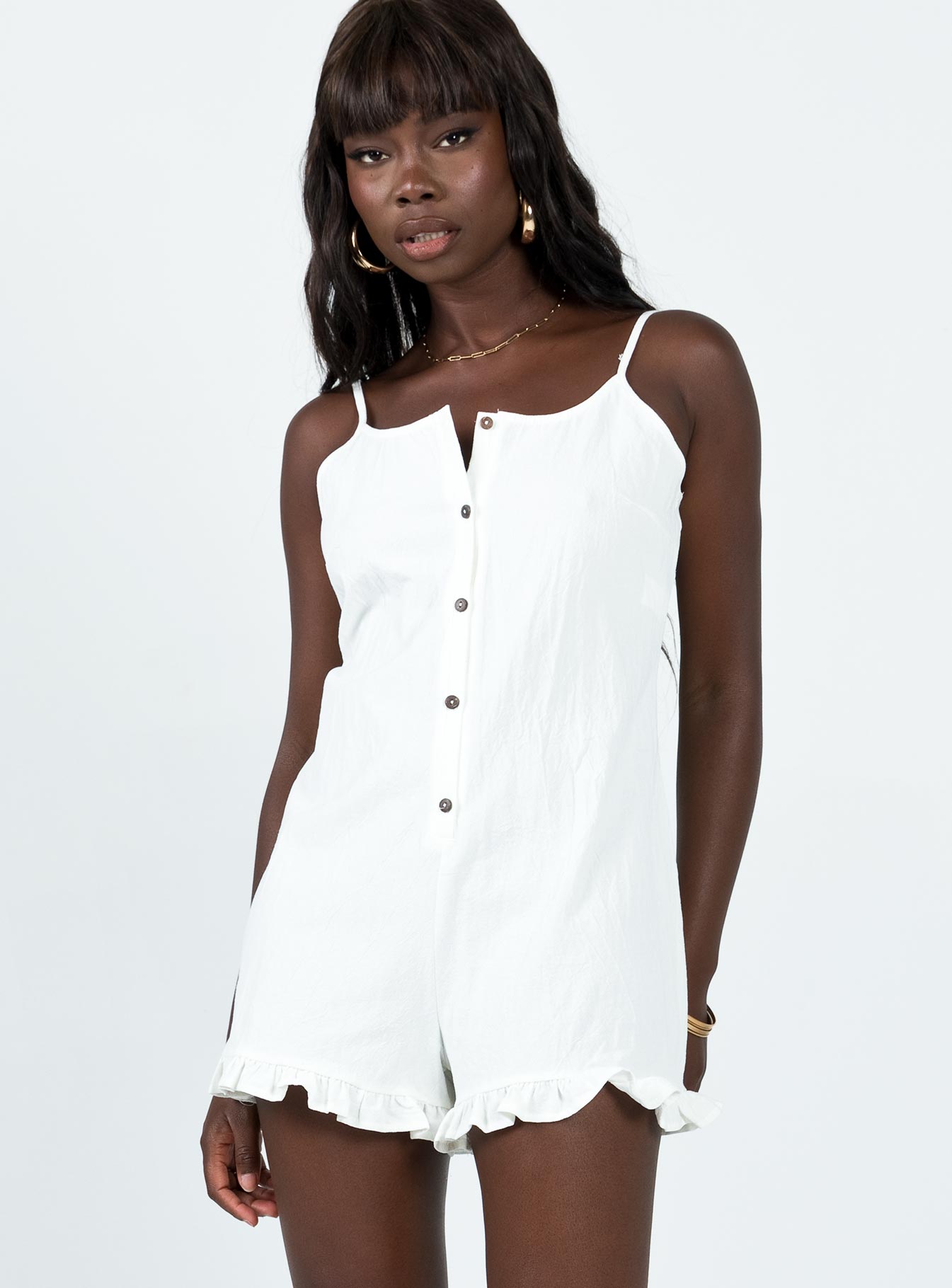 Playsuit Adjustable shoulder straps Scooped neckline Button fastening at front Frill hem Non-stretch