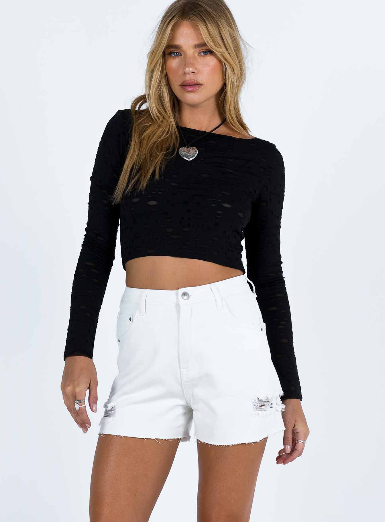 White denim shorts High waisted Belt looped waist Classic five pocket design Button and zip fastening Distressed detail on leg Raw cut hem 