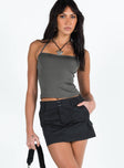 Black mini skirt Mid to low rise Double button and zip fastening Belt looped waist Four pocket design