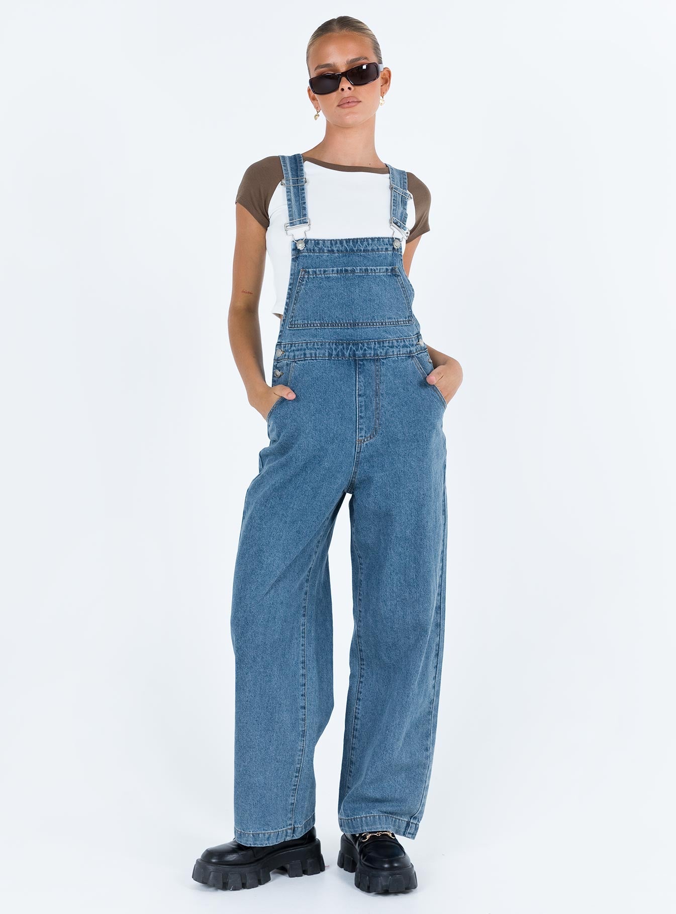 Overalls Mid wash denim Adjustable shoulder strap  Large chest pocket  Four classic pockets  Button fastening at hips  Wide leg