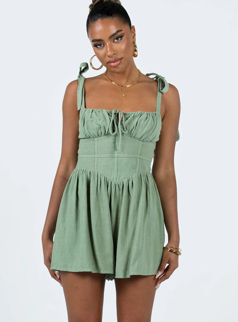 Romper Adjustable shoulder straps with tie fastening  Ruched bust Invisible zip fastening at back Slight ruching at waist