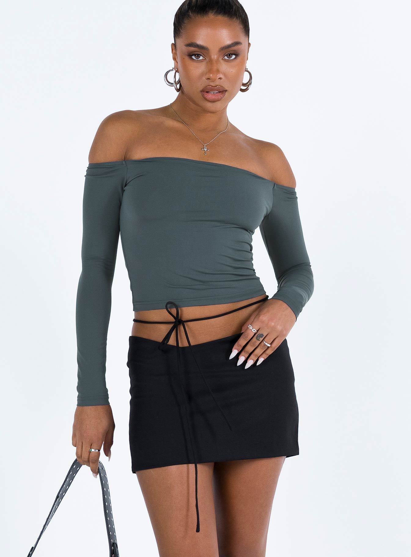 Black mini skirt Low rise Asymmetric waist Tie fastening at waist Invisible zip fastening at side