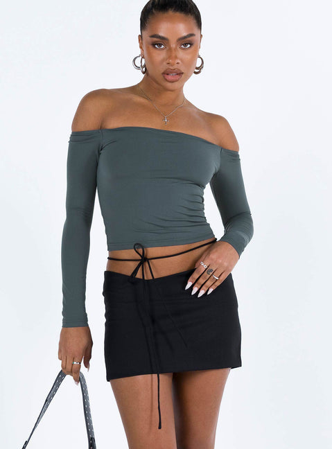 Black mini skirt Low rise Asymmetric waist Tie fastening at waist Invisible zip fastening at side