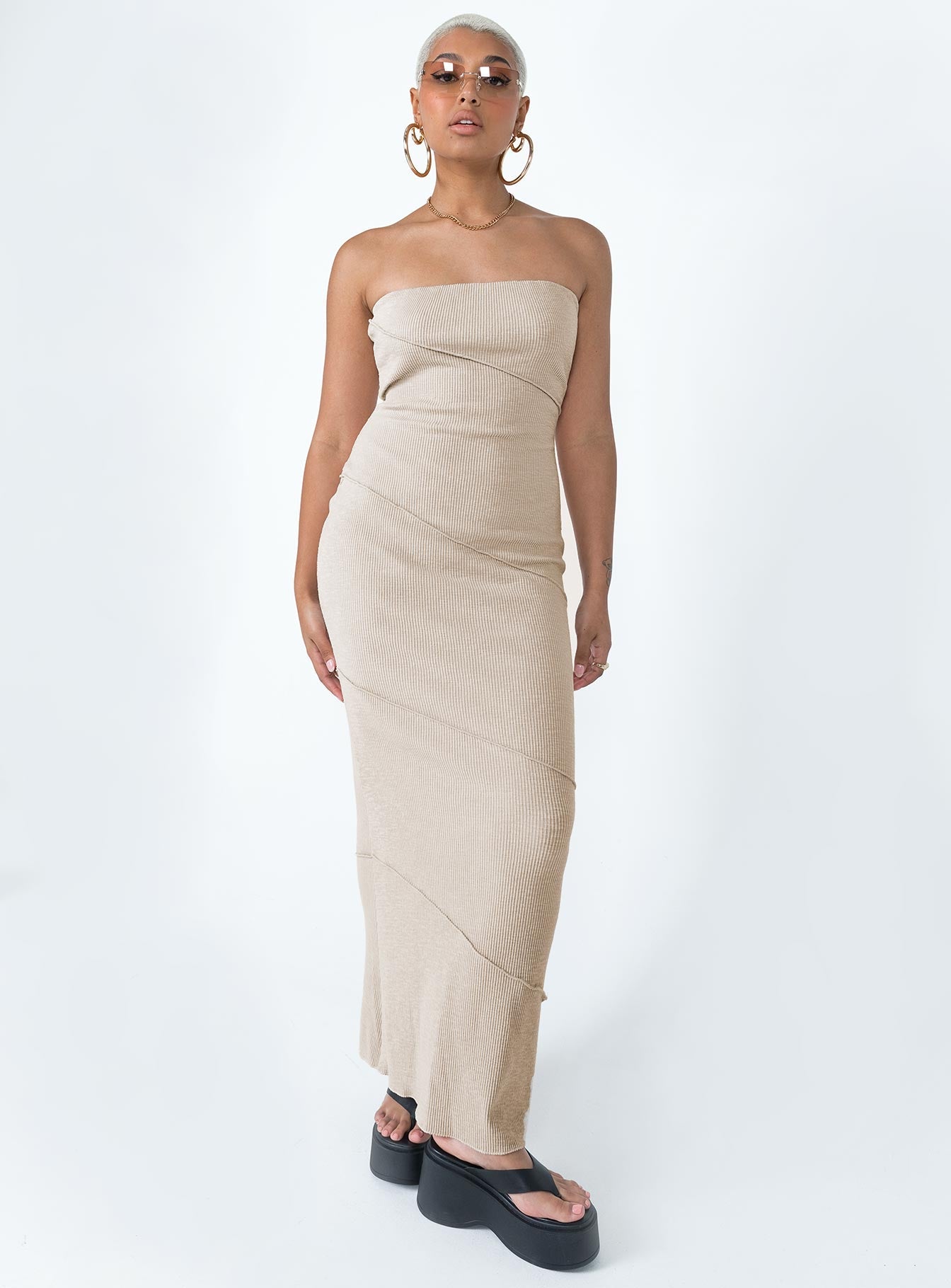 Strapless midi dress Soft knit material Diagonal stitching Inner silicone strip at bust Invisible zip fastening at side Good stretch