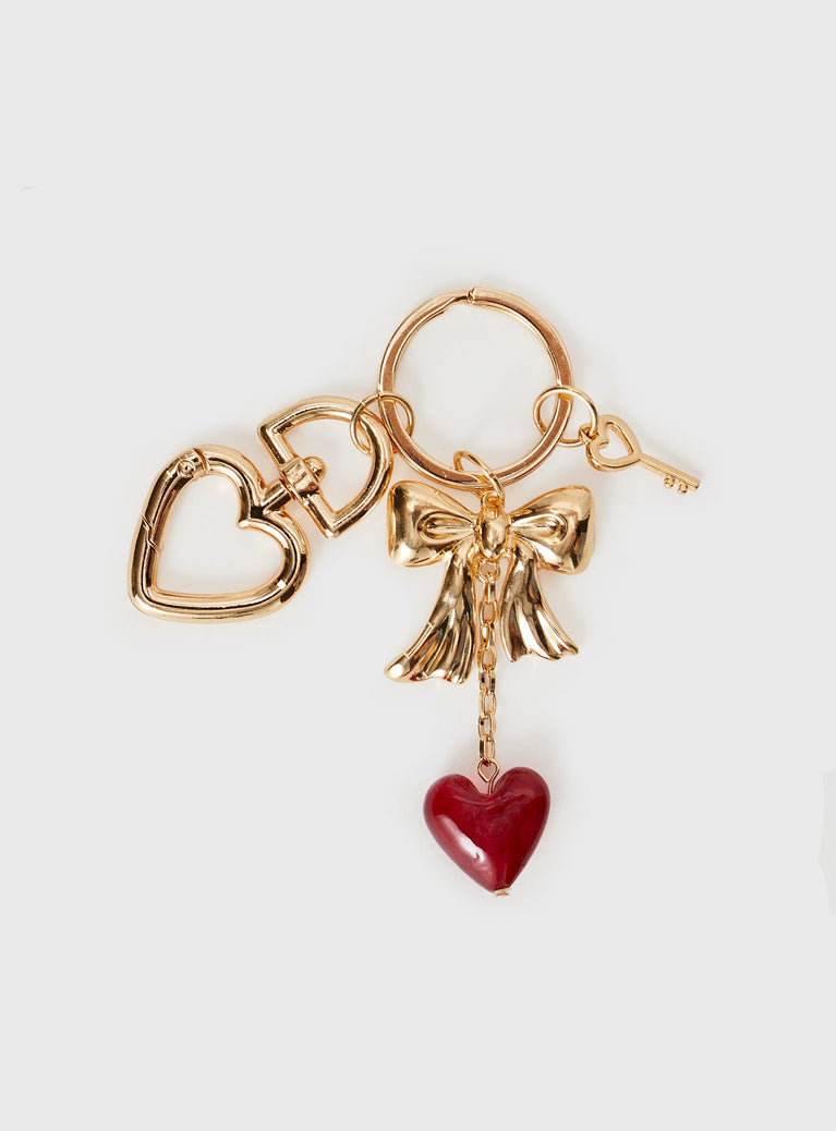 Gold toned keyring with three removable charms