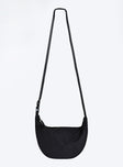 Black crossbody bag Nylon material Adjustable strap Zip fastening Internal slip pocket Silver toned hardware