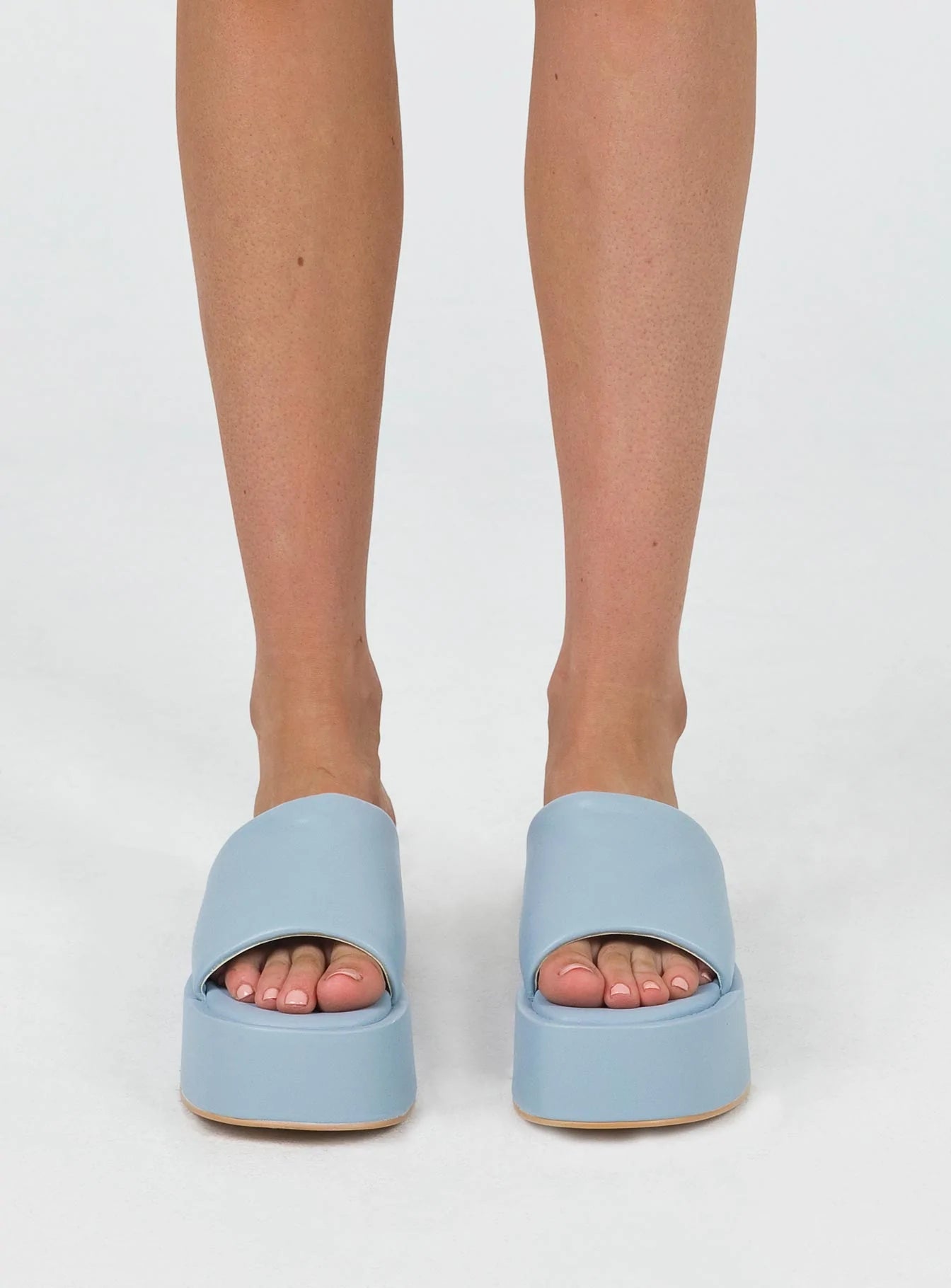 Sandals Faux leather  Wide upper  Slit at side for movement Square toe  Padded footbed  Platform base 