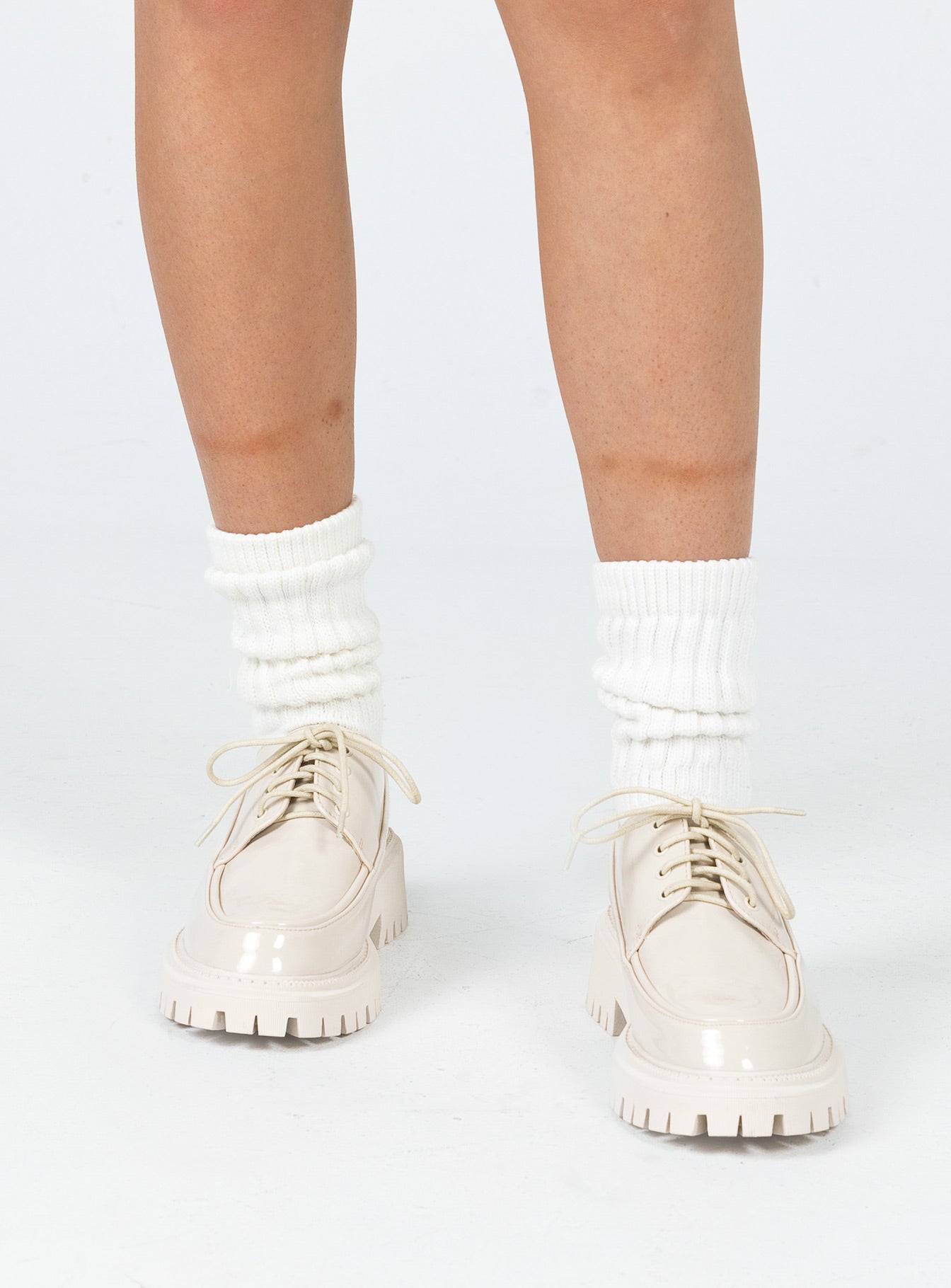 Shoes Faux leather material  High shine  Lace up  Rounded toe  Pull tab at heel  Platform base  Treaded sole 