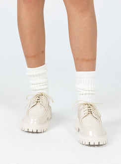 Shoes Faux leather material  High shine  Lace up  Rounded toe  Pull tab at heel  Platform base  Treaded sole 