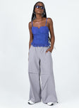 Blue top Lace material Adjustable shoulder straps Wired cups Zip fastening at back Boning through front Frill hemline