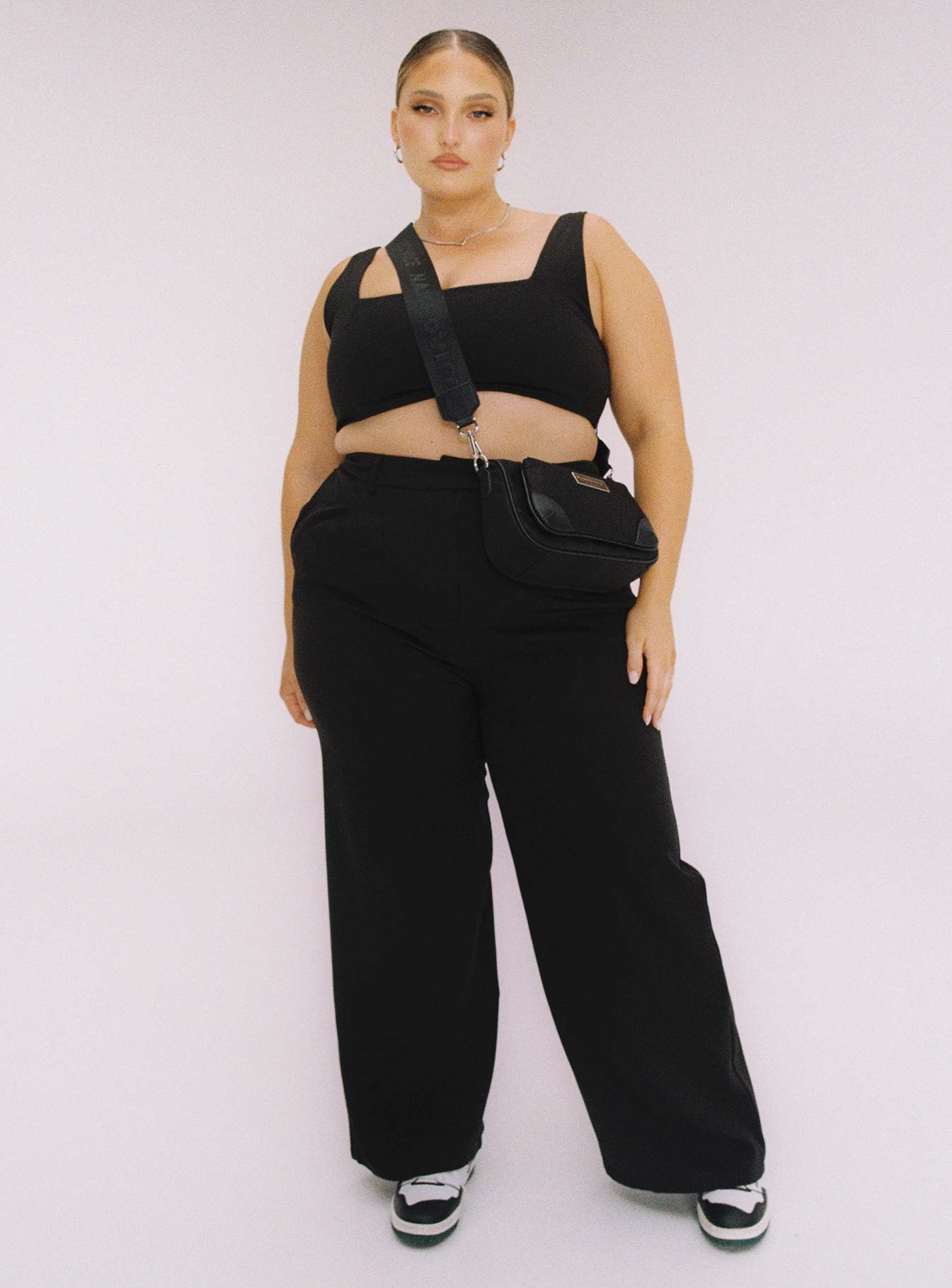 Black matching set Crop top Fixed straps Invisible zip fasting at side High waisted pants Wide relaxed leg Belt loops at waist Zip & button fastening