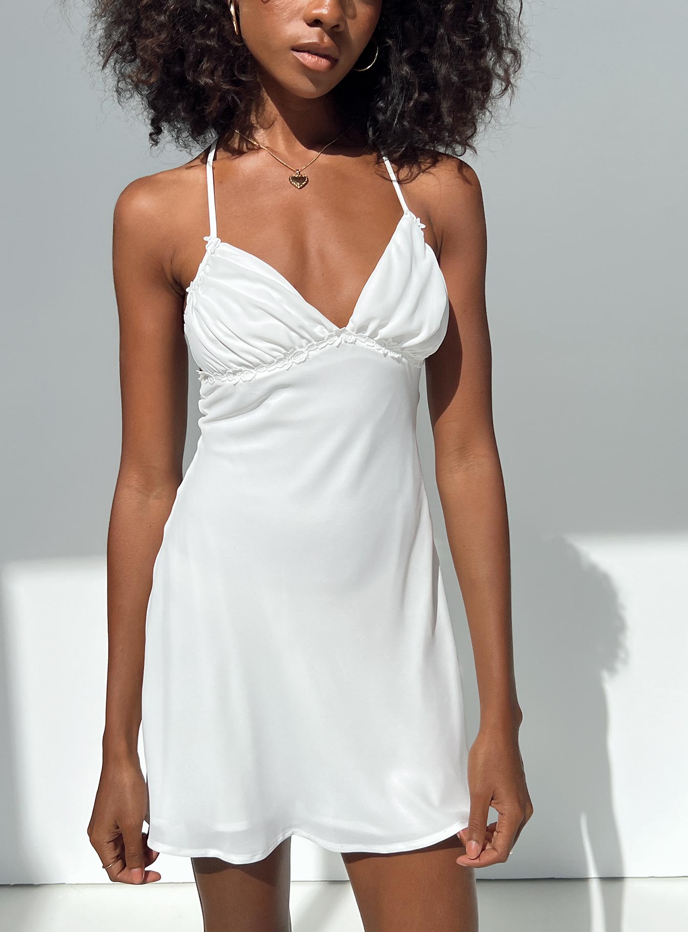 White mini dress Adjustable shoulder straps V neckline Knitted lace detail Cross straps at back Invisible zip fastening at side
