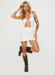 Two piece broderie anglaise set Crop top, Fixed shoulder straps, v-neckline, tie fastening at bust, split hem High rise mini skirt, invisible zip fastening at side