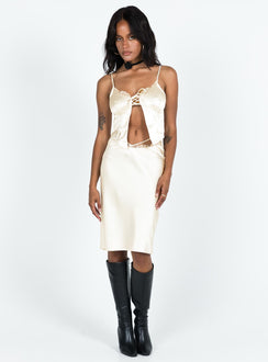 Cami top Silky material Adjustable shoulder straps Lace trim Scooped neckline Lace up fastening at bust Split hem