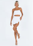 White two piece set Strapless crop top Pearl embellishments at bust Boning through bust Invisible zip fastening at back  Mini skirt Side split Invisible zip fastening at side