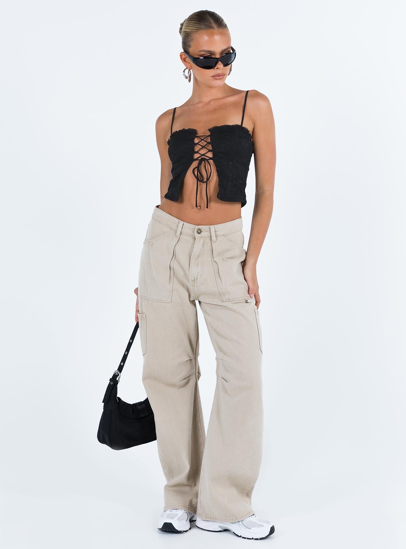 Crop top Lace material  Ruffle neckline  Adjustable shoulder straps  Inner silicone strip at bust  Lace up fastening at front Non stretch Fully lined 