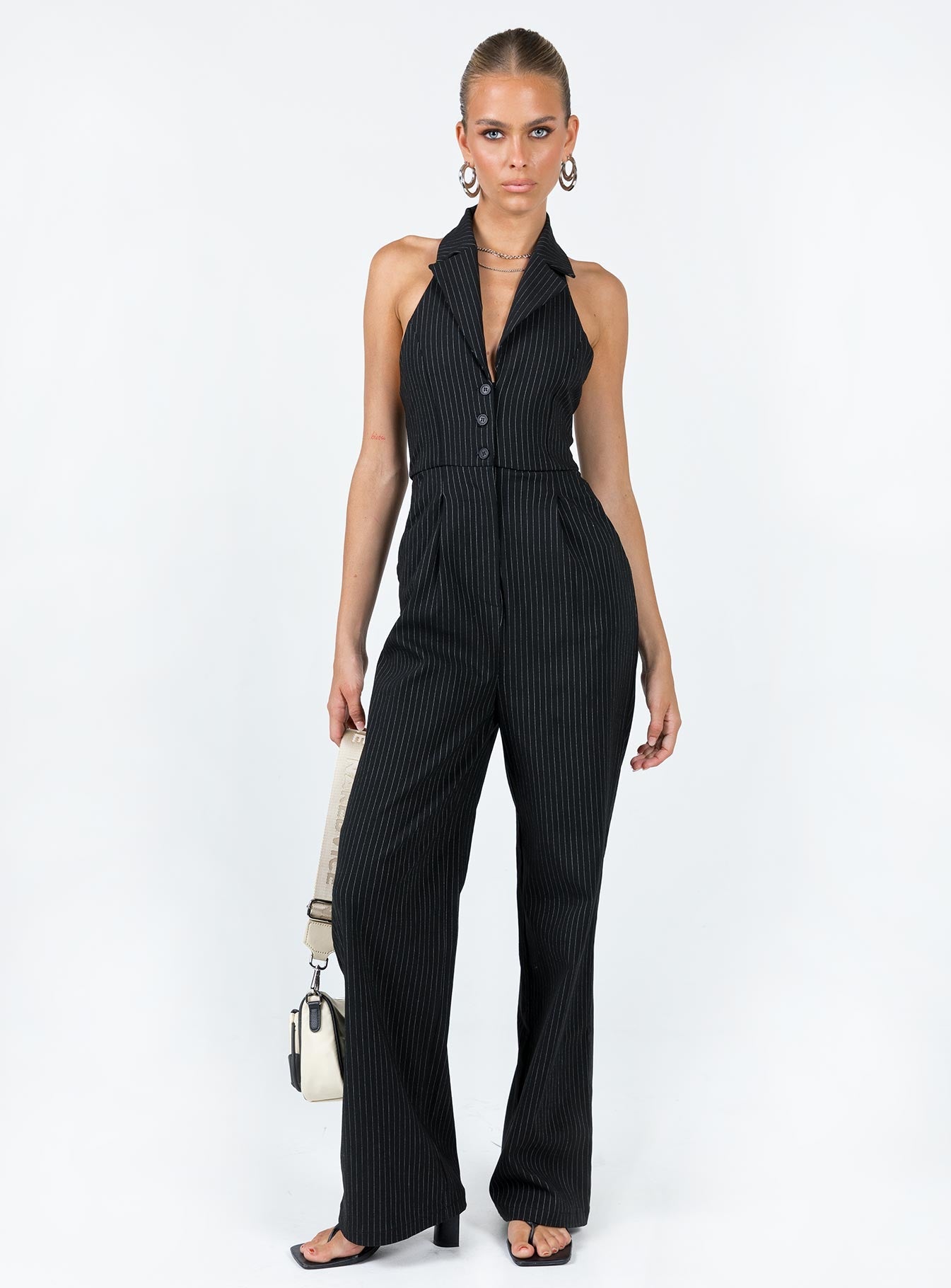 Jumpsuit  Princess Polly exclusive Main: 100% brocade cotton  Lining: 95% polyester 5% elastane Pinstripe print  Halter neck Lapel collar  Plunging neckline  Button & zip front fastening  Exposed back  Twin hip pockets  Faux back pockets  Wide leg 