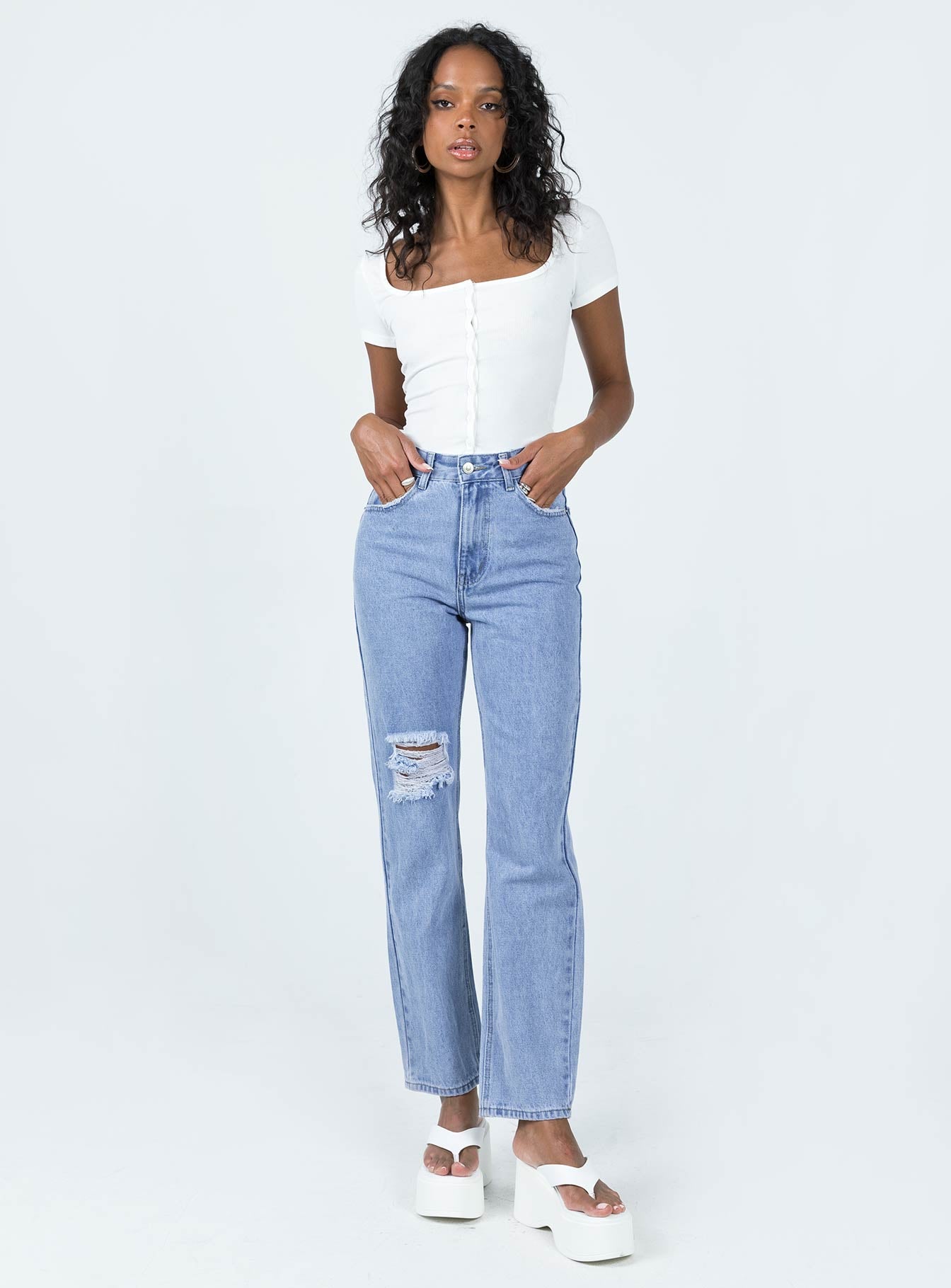 Jeans Mid wash denim Belt looped waist Classic five-pocket design Zip & button fastening High waisted Ripped knee