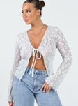 Long sleeve top Sheer lace material V-neckline Single tie fastening at bust Flared sleeve