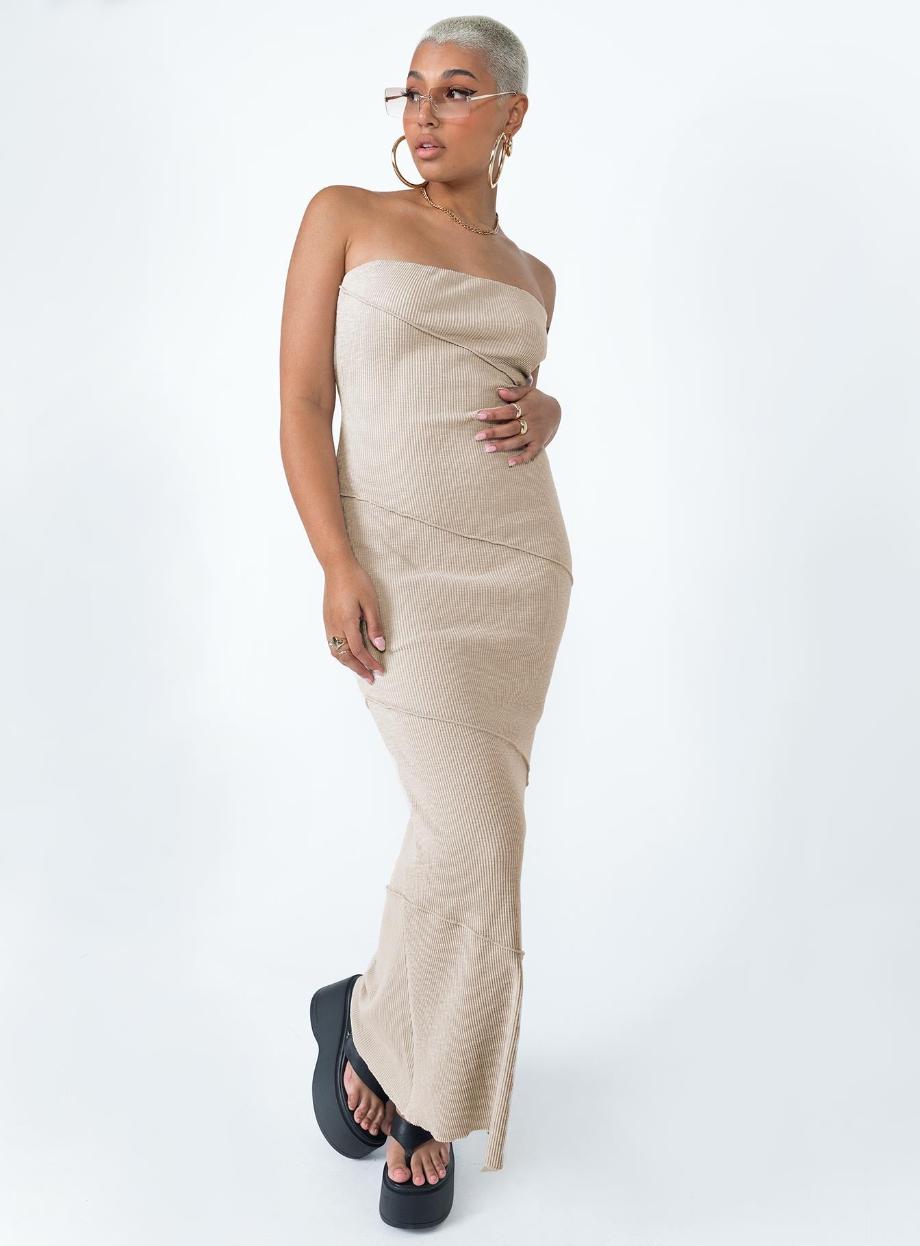 Strapless midi dress Soft knit material Diagonal stitching Inner silicone strip at bust Invisible zip fastening at side Good stretch