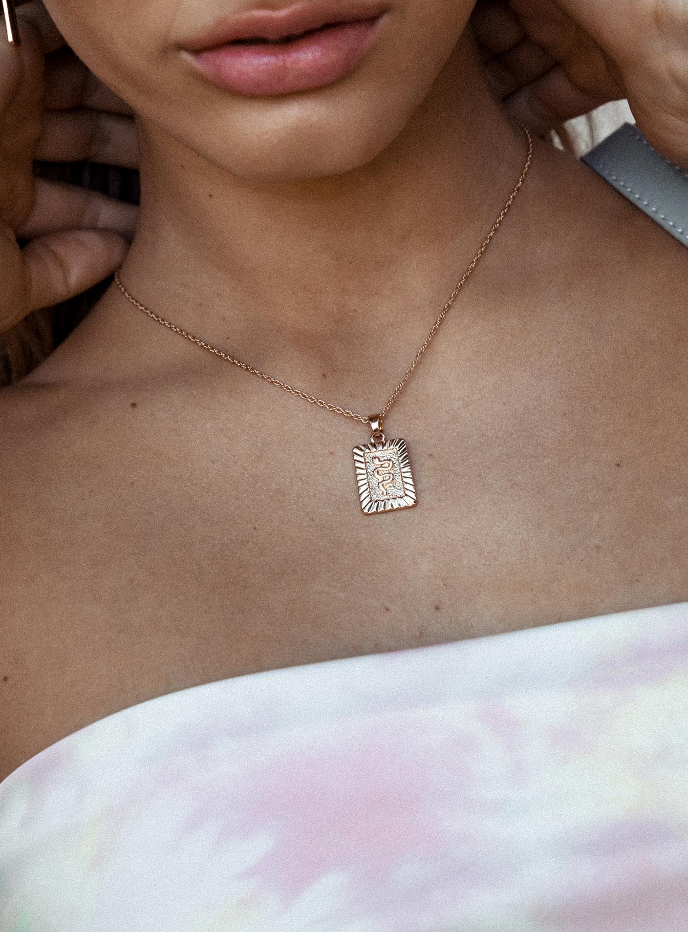 Necklace Drop charm with snake detail Dainty rope chain Gold toned hardware Lobster clasp fastening