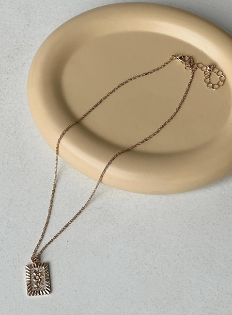 Necklace Drop charm with snake detail Dainty rope chain Gold toned hardware Lobster clasp fastening