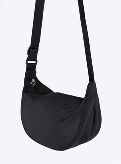 Black crossbody bag Nylon material Adjustable strap Zip fastening Internal slip pocket Silver toned hardware