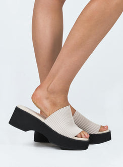 Sandals Faux leather material Single stretch knit upper Padded footbed Square toe Slip-on style