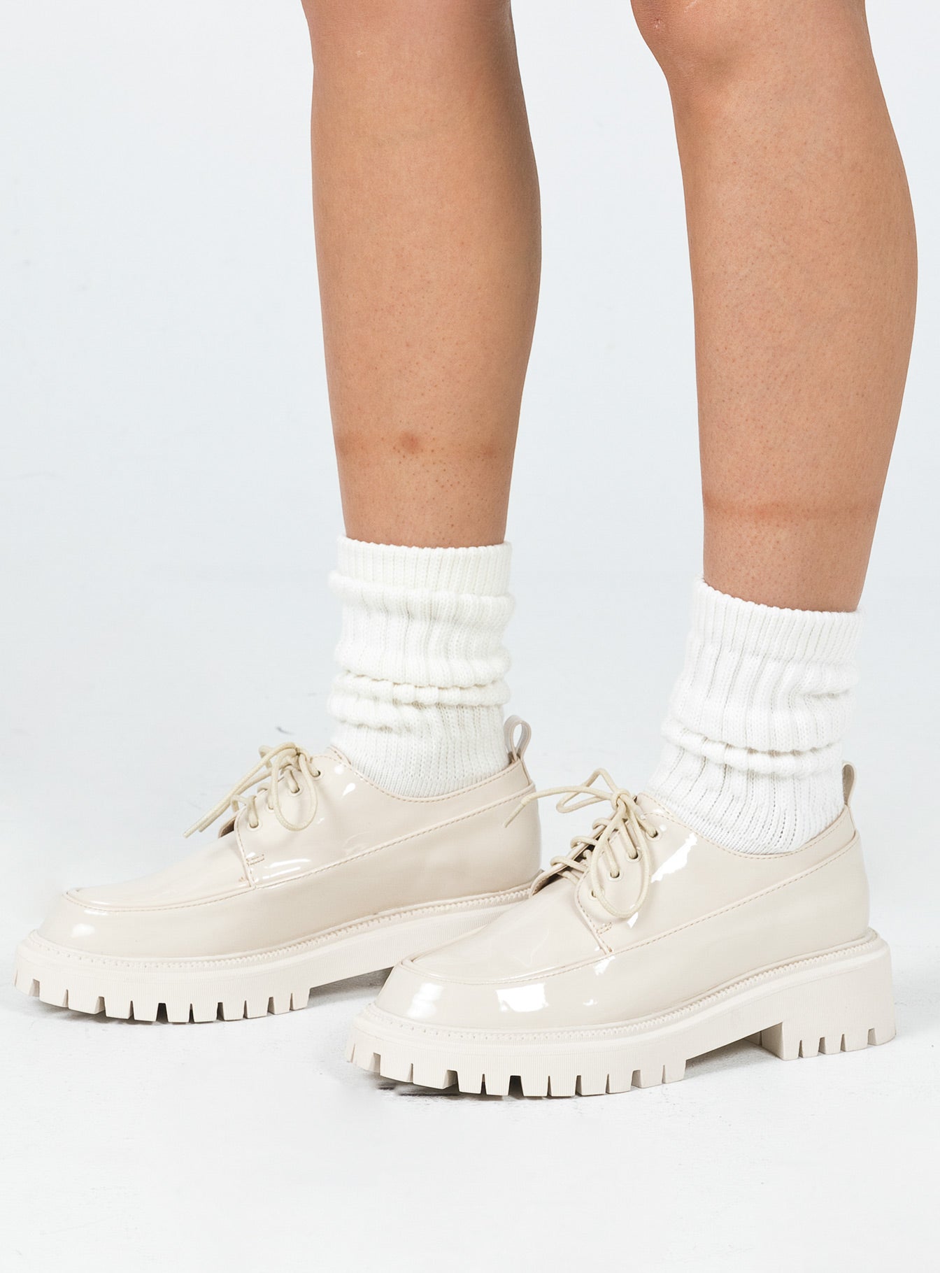 Shoes Faux leather material  High shine  Lace up  Rounded toe  Pull tab at heel  Platform base  Treaded sole 