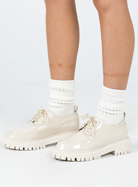 Shoes Faux leather material  High shine  Lace up  Rounded toe  Pull tab at heel  Platform base  Treaded sole 