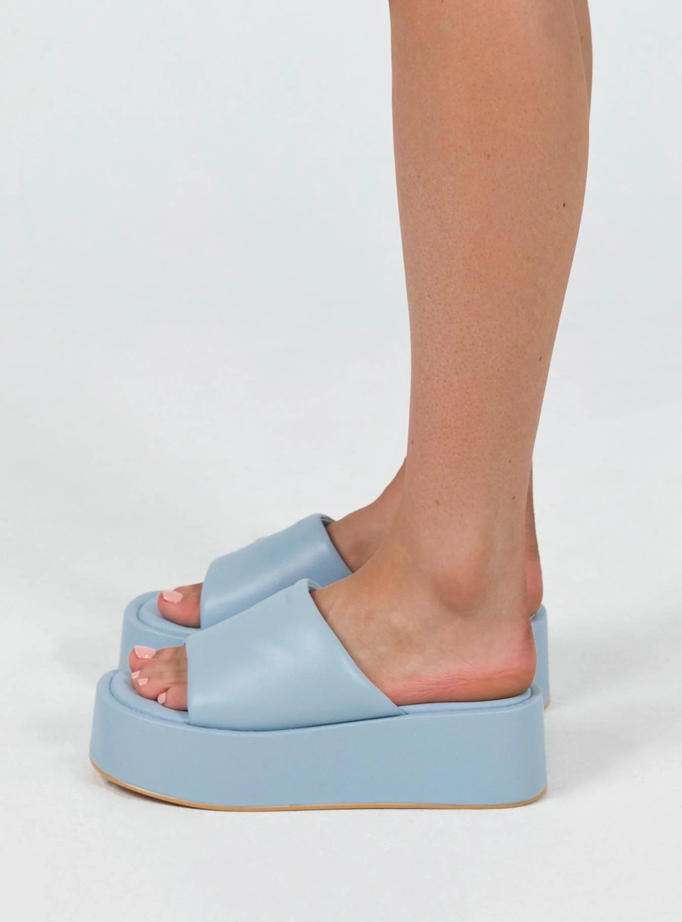 Sandals Faux leather  Wide upper  Slit at side for movement Square toe  Padded footbed  Platform base 