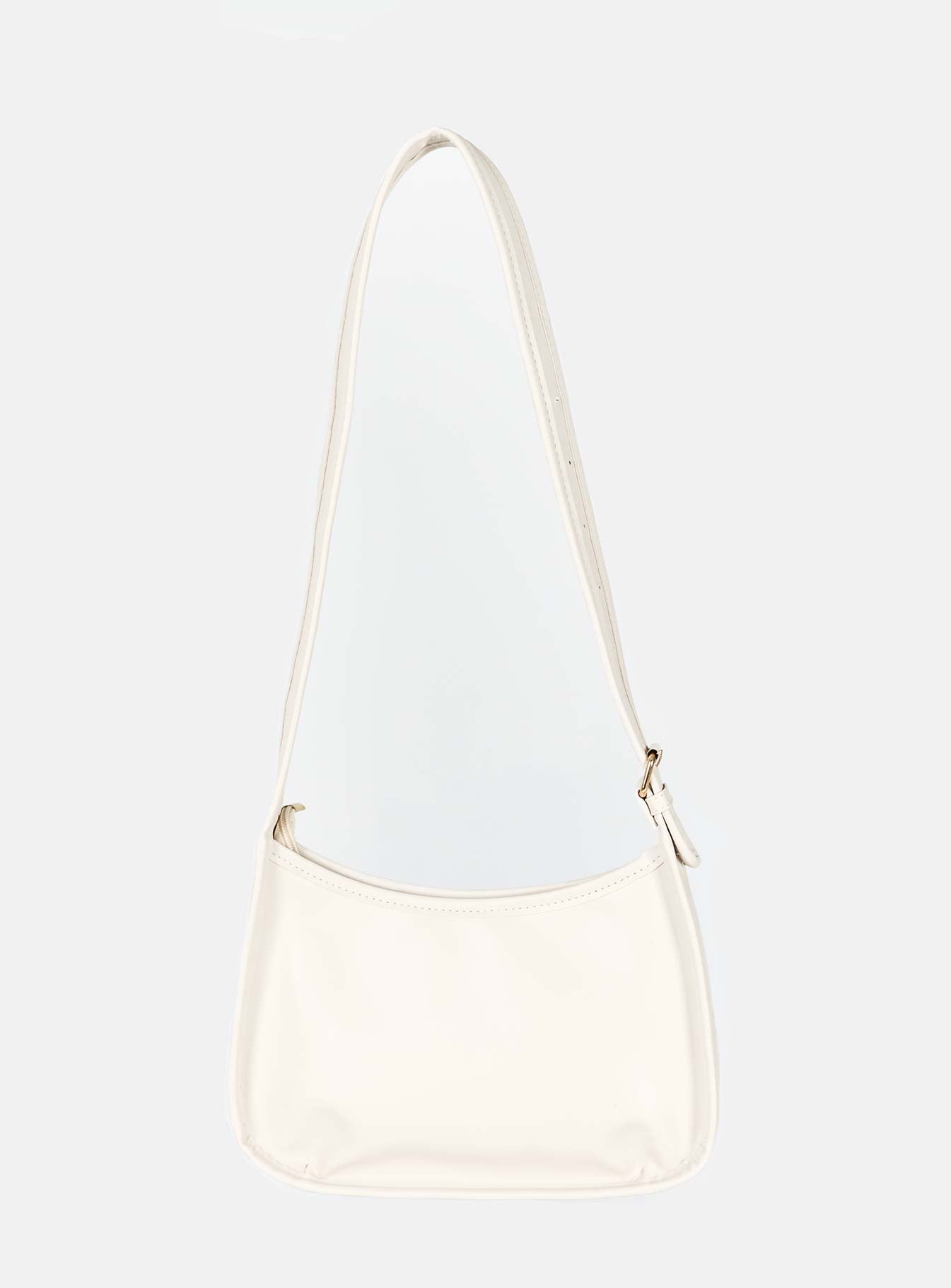 Cream crossbody bag Faux leather material Adjustable crossbody strap Gold-toned hardware Zip fastening Slip at back Flat base