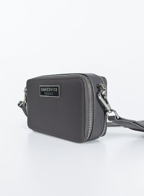 Crossbody bag Faux leather trims Adjustable & removable strap Two separate compartments Zip fastening Silver-toned hardware Branded plaque at front Flat base