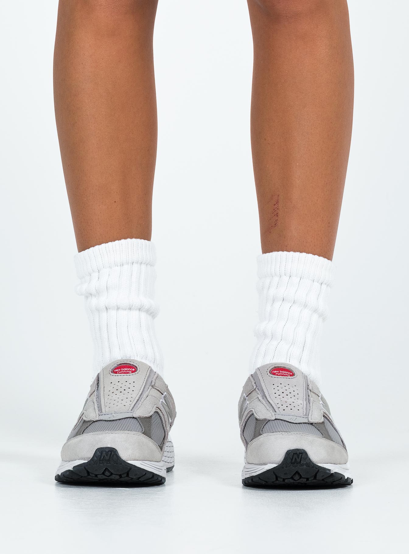 Faux suede sneakers, slip-on style Padded footbed, mesh netting detail, treaded sole