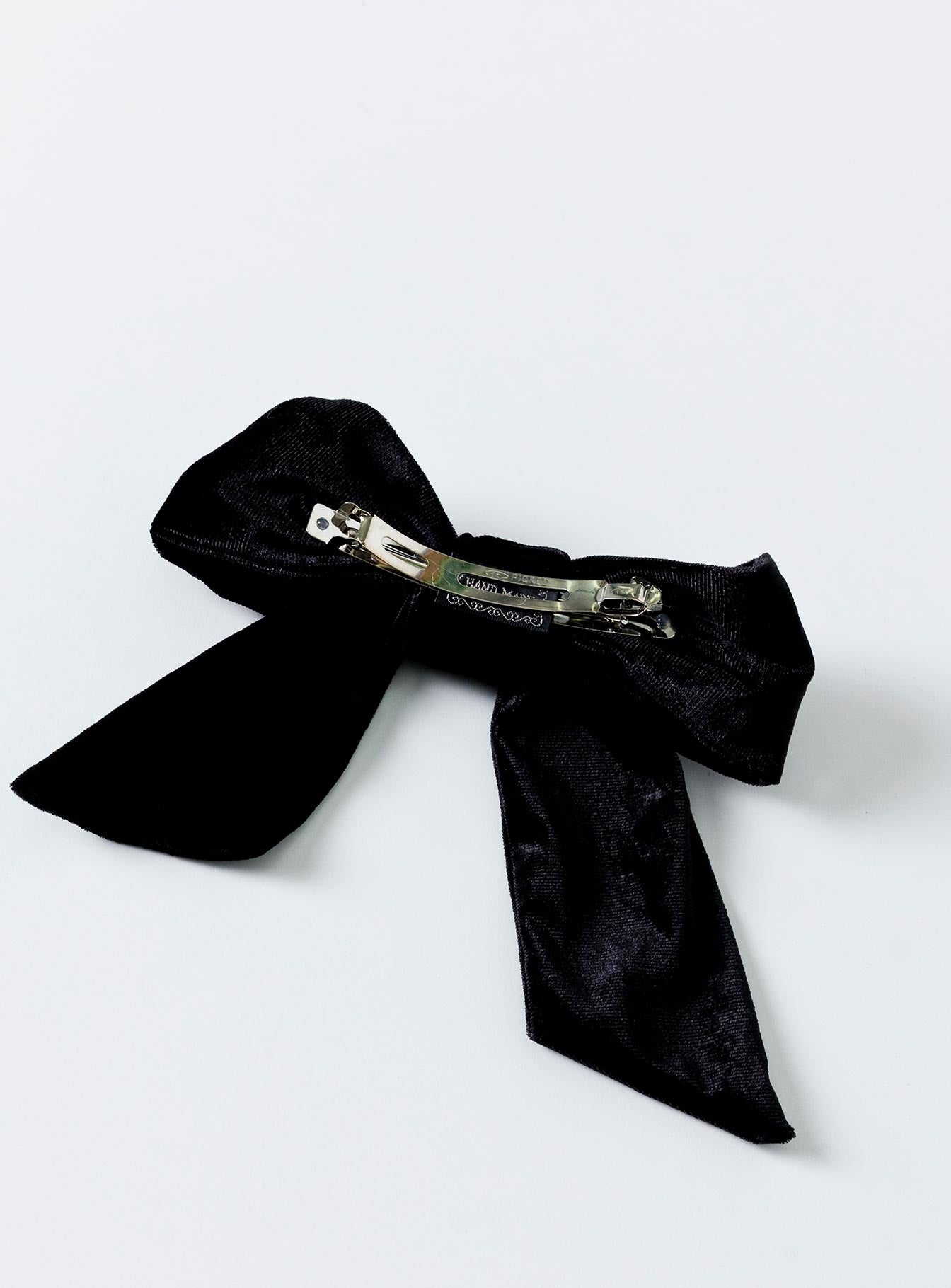 Black Bow hair clip  90% polyester 5% spandex 5% iron Velour material  Silver-toned hardware  Snap slip fastening