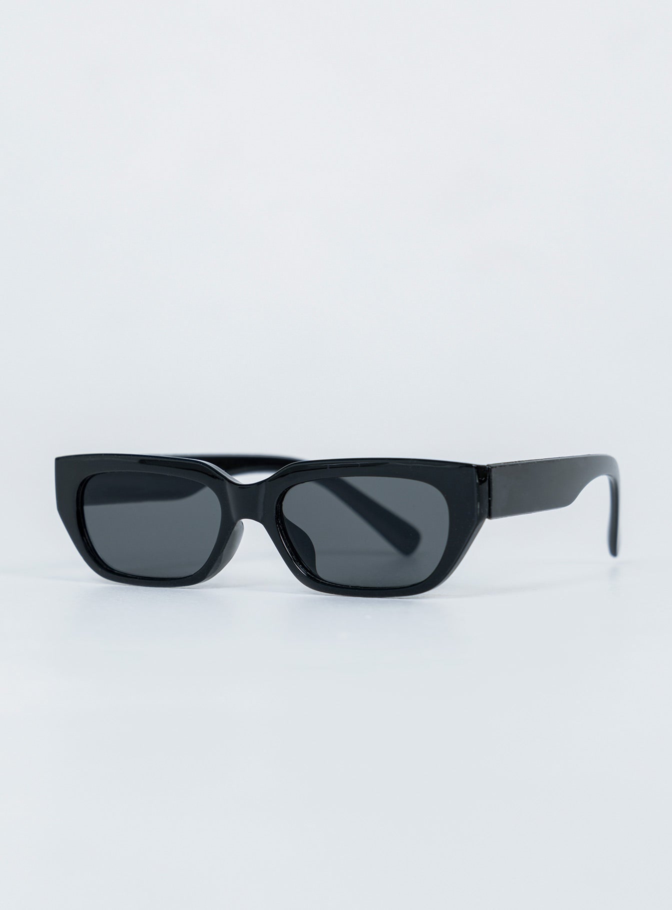 Sunglasses  100% plastic  UV 400 Slim style Transparent frame  Moulded nose bridge  Grey tinted lenses 