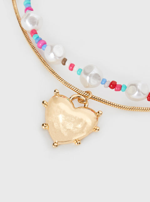 Gold-toned necklace Bead detail, heart pendant, two fixed chins - these cannot be worn separately, lobster clasp fastening