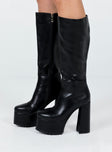 Platform boots Princess Polly Exclusive Faux leather material Knee high Zip fastening at side Block heel Rounded toe Treaded sole