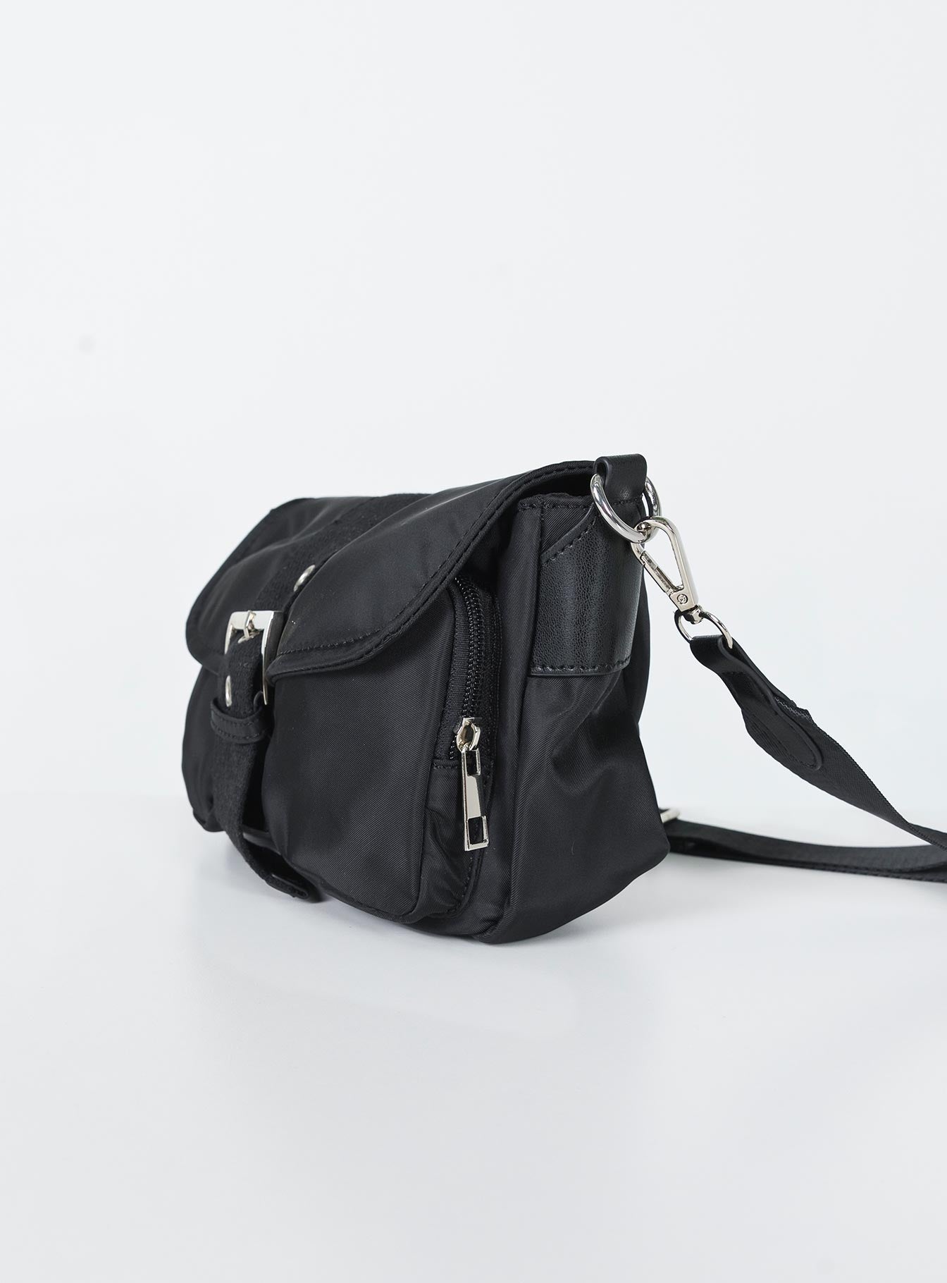 Crossbody bag  Princess Polly Exclusive Nylon material  Silver-toned hardware  Removable & Adjustable strap Magnetic button fastening  Zip closure Two external pockets  Fully lined  Flat base 