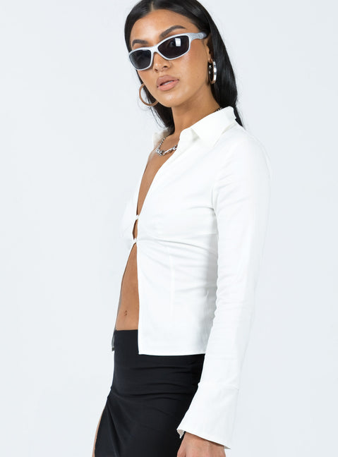 Long sleeve shirt Classic collar V-neckline Button fastening at front Split hem Open back design with lace-up fastening Slits at cuffs